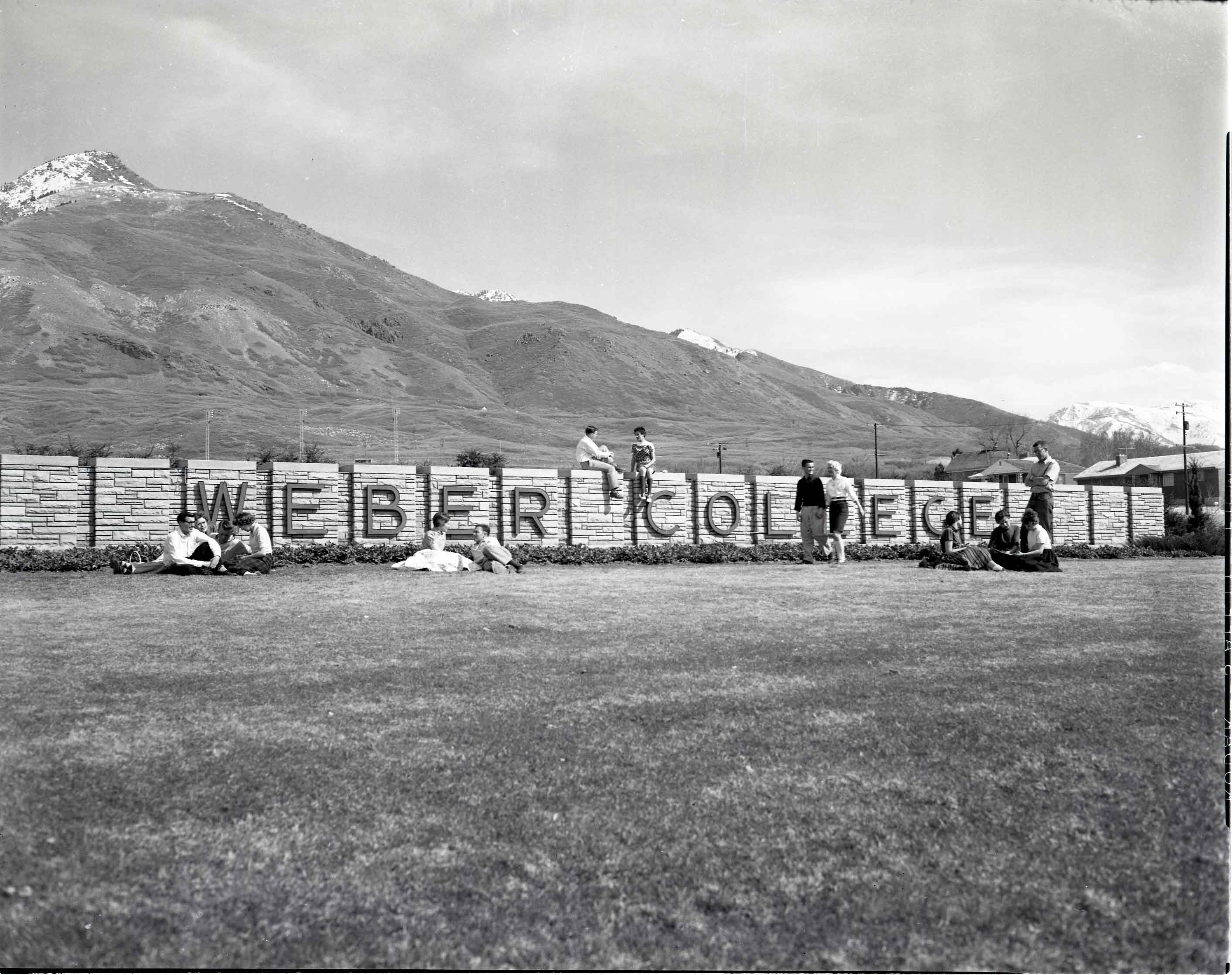 Students lounge on the Weber College Rock Wall circa 1950s