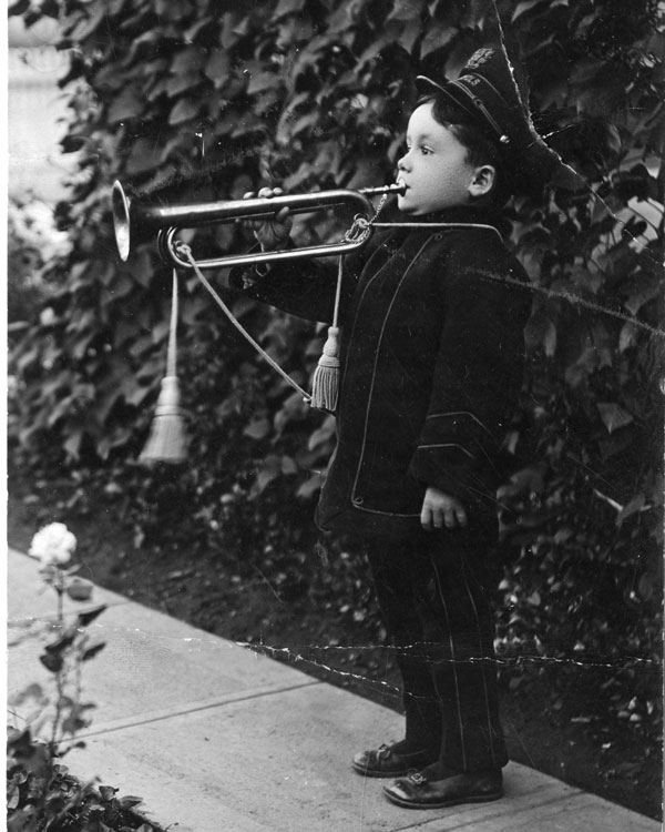 Little kid playing a trumpet