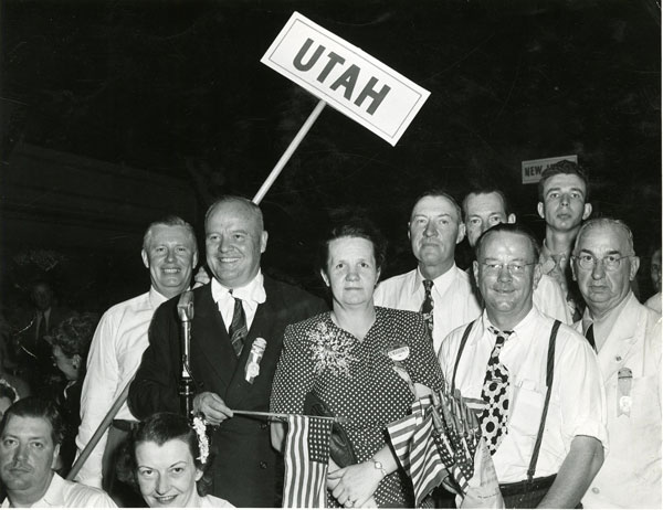 Group of people holding a sign that says UTAH