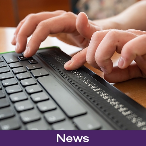Person typing on a braille keyboard
