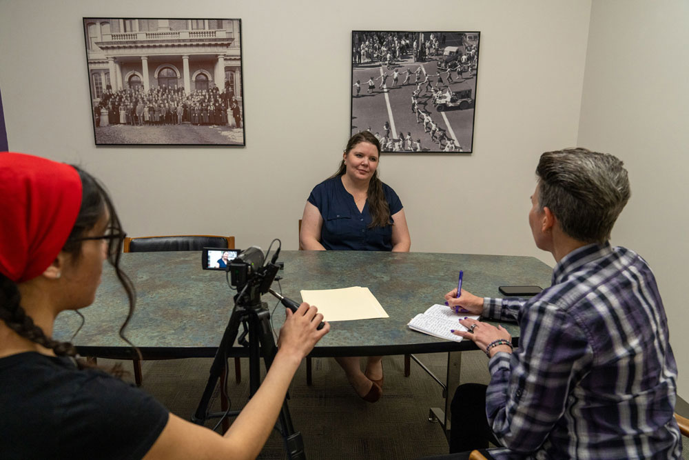 Two people interviewing someone